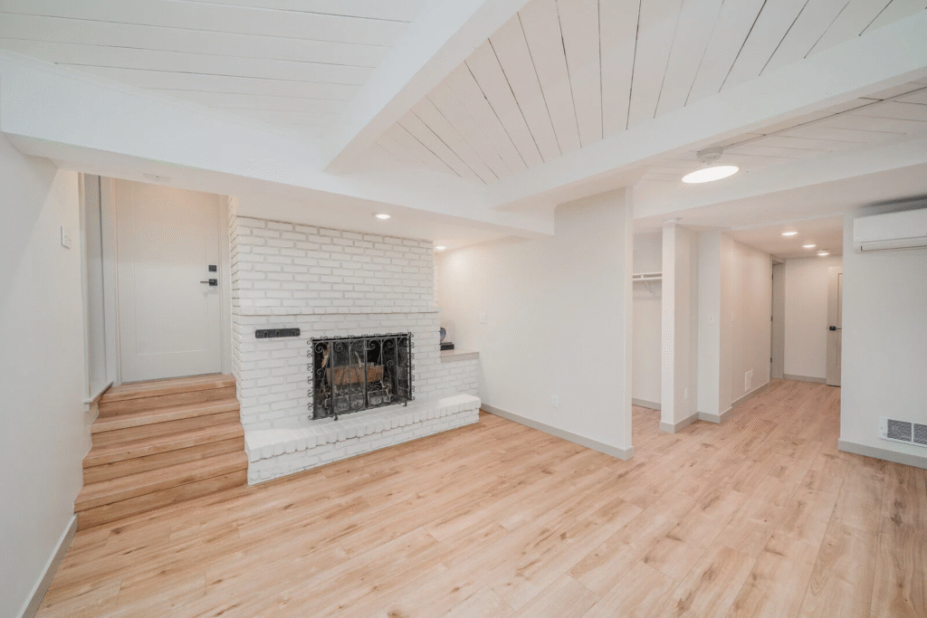 Basement Remodeling in Dallas featuring modern lounge, pool table, bar, and fireplace design.