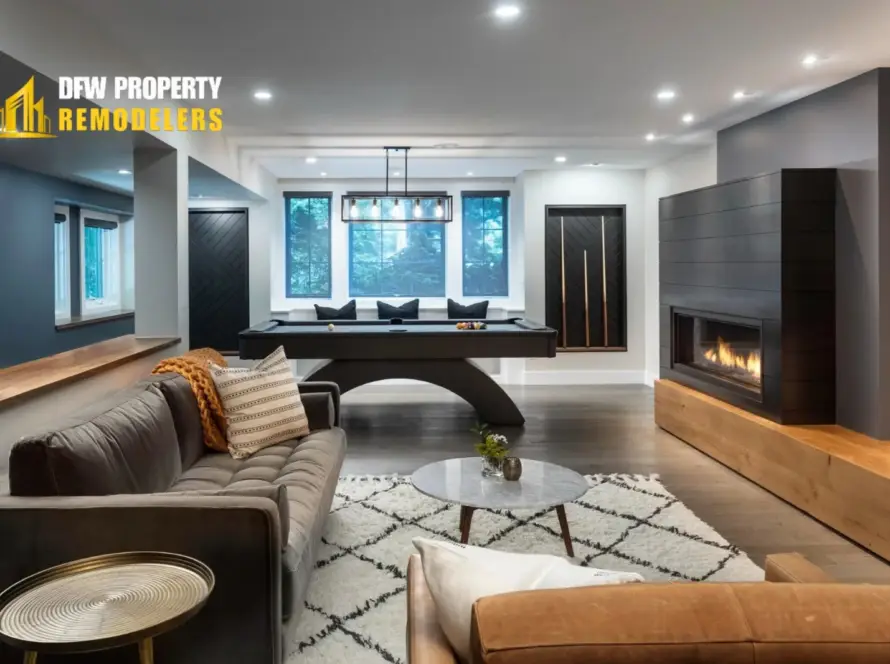 Modern basement by DFW Property Remodelers shows a home remodeling timeline featuring a sleek pool table and fireplace.