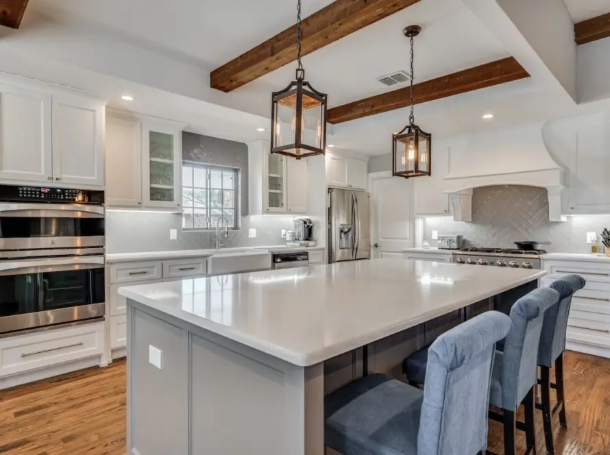 Modern white kitchen remodel with island wood beams – best remodeler Dallas TX