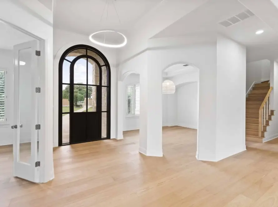 Dallas home renovation cost guide showcasing modern interior with arched door, wood floors, stairs